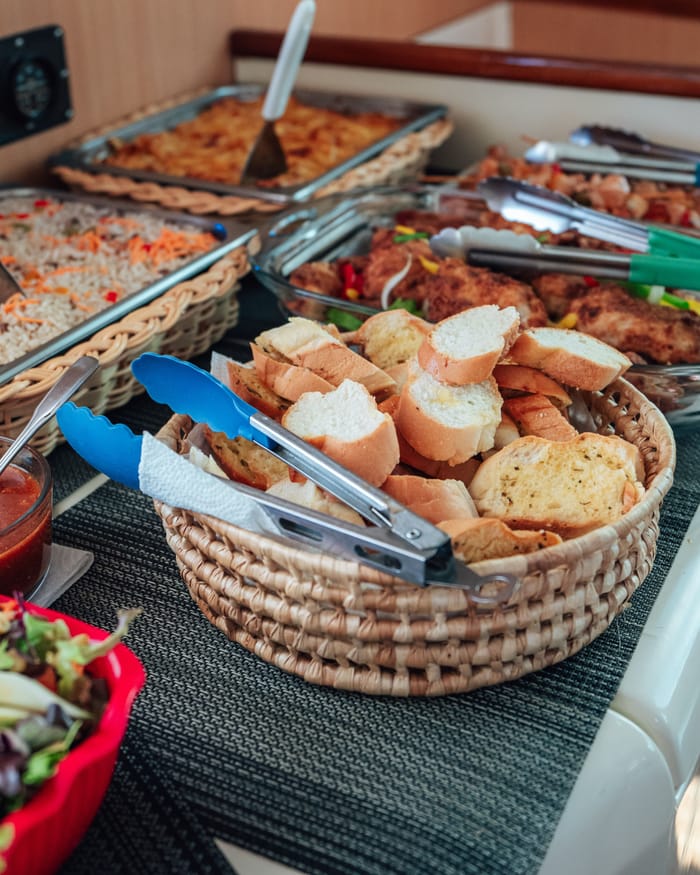 The buffet on board: baskets of bread, salads and hot trays
