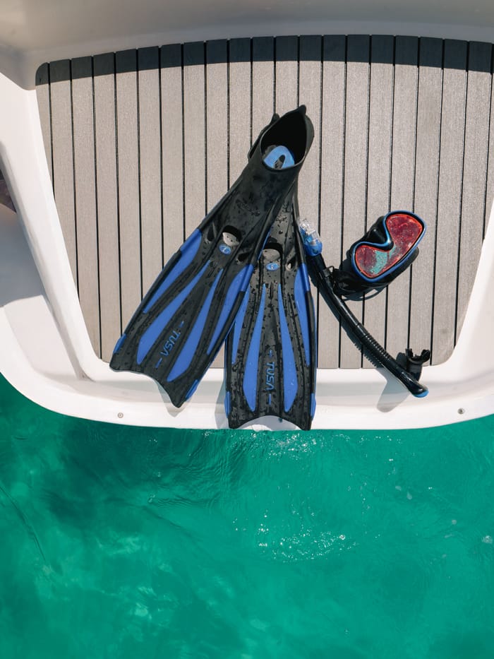 Fins and a mask laid out on the stern step, ready for the first snorkel stop